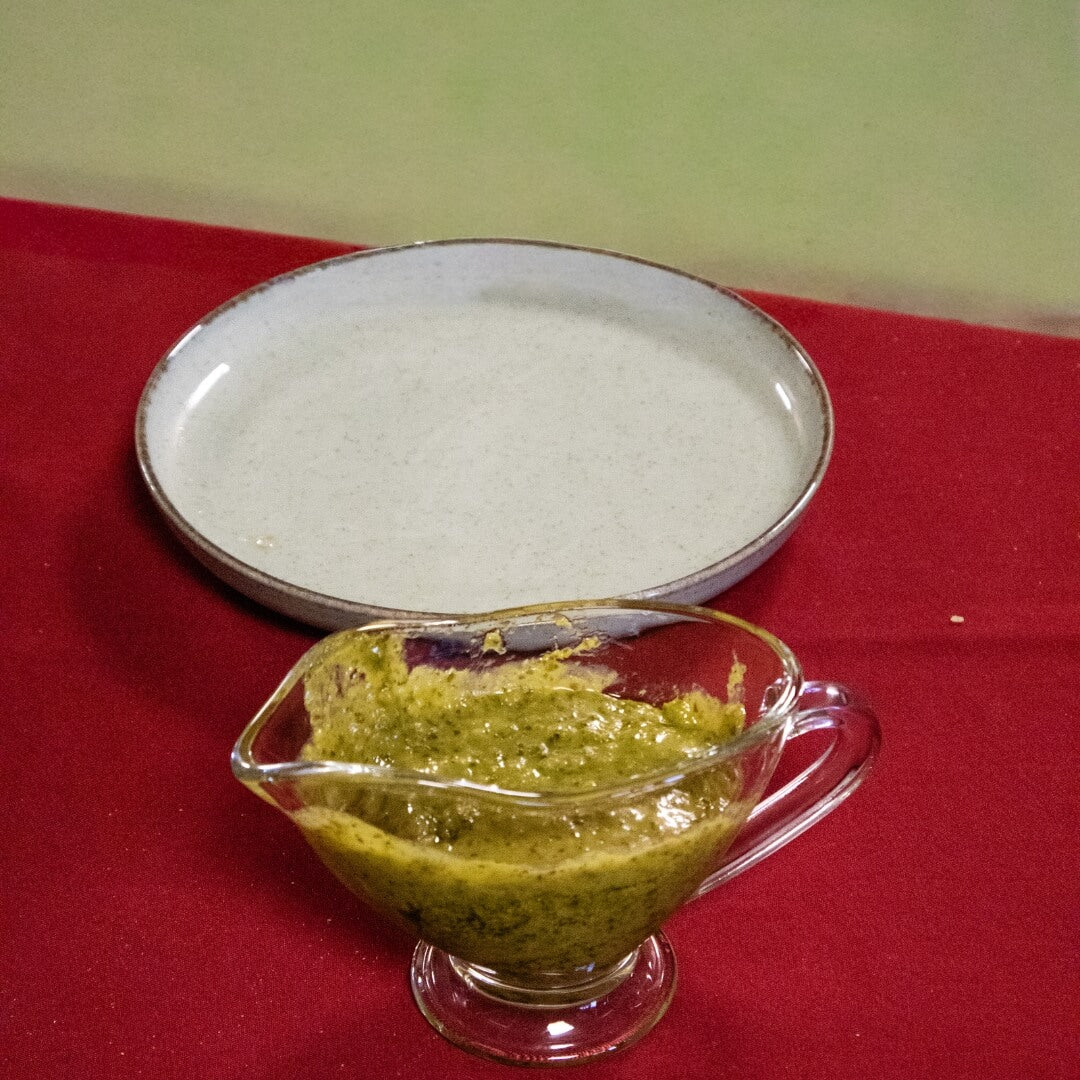 Opened Nordama Bio-Pesto jar with basil pesto served in a small glass bowl